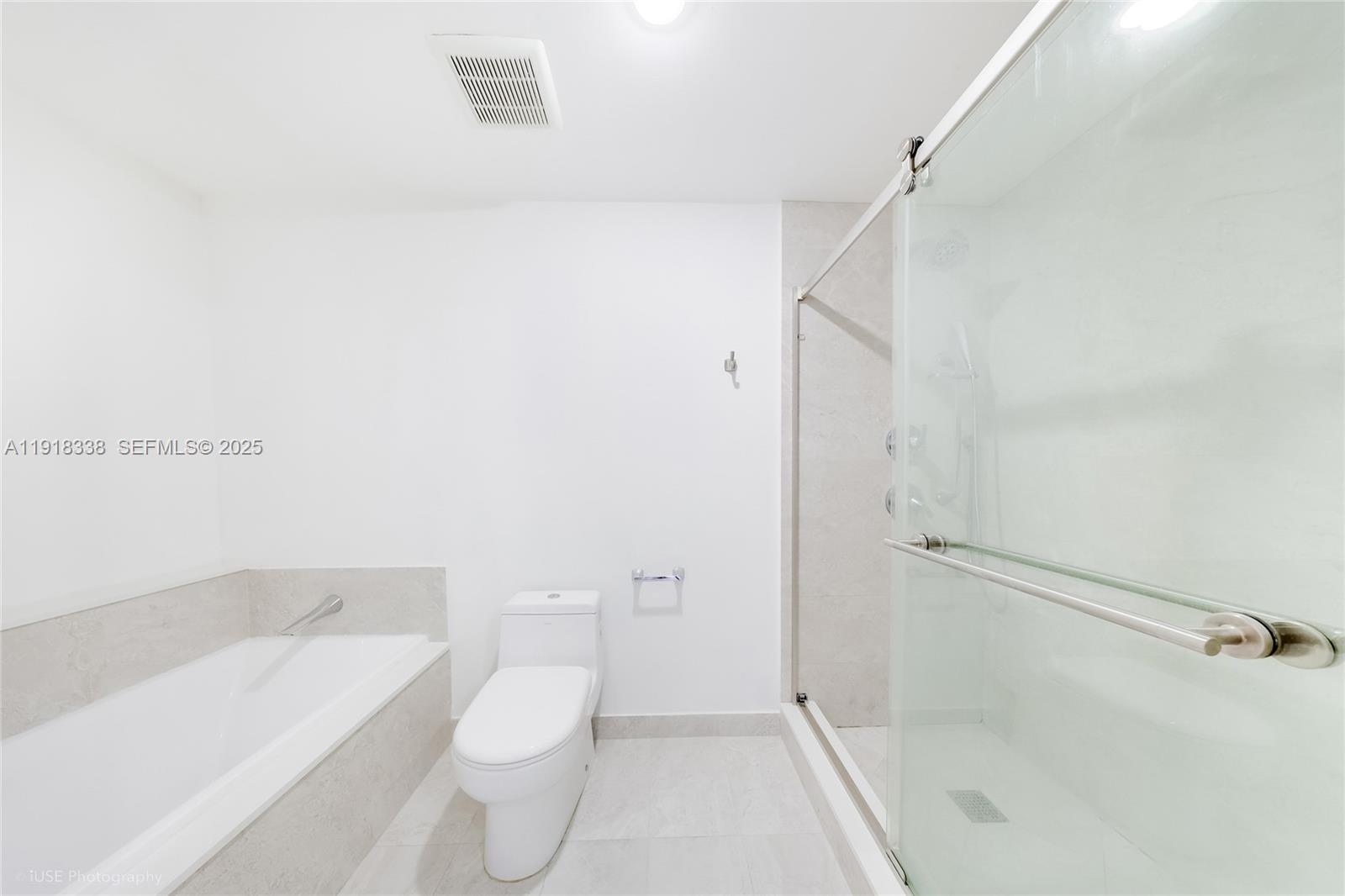 488 Northeast 18th Street, Unit 2304 Miami, FL 33132 - Photo 12 of 41 a bathroom with a toilet and a shower