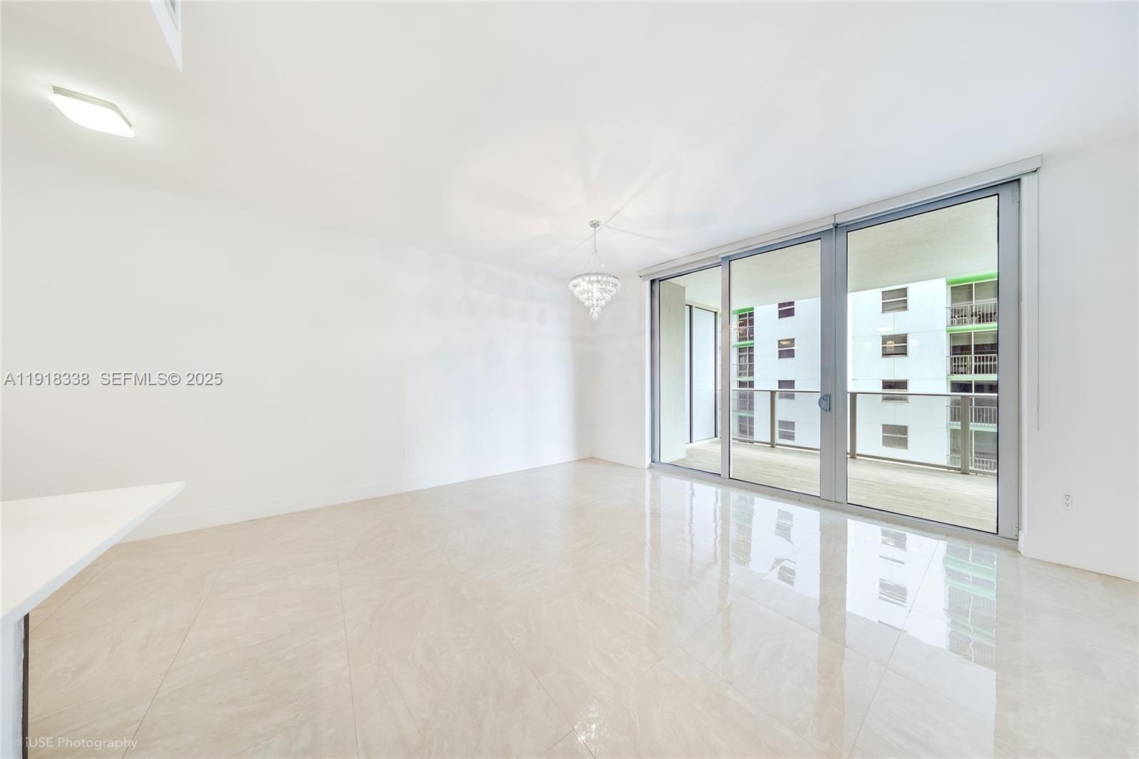 488 Northeast 18th Street, Unit 2304 Miami, FL 33132 - Photo 8 of 41 a view of an empty room with wooden floor and a window