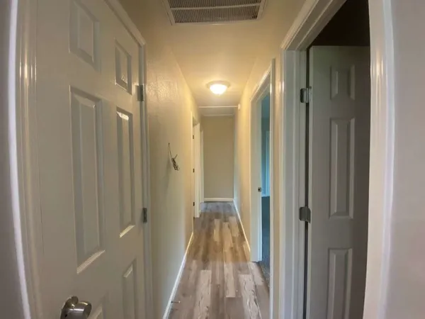 a view of a bathroom from a hallway
