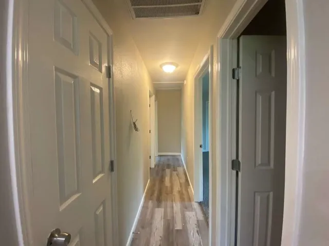 a view of a bathroom from a hallway