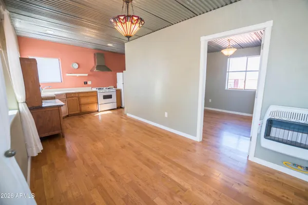 a kitchen with a stove top oven and refrigerator