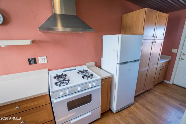 en empty room with wooden floor and large window