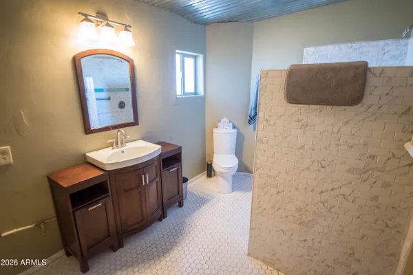a view of a balcony with wooden floor and outdoor seating