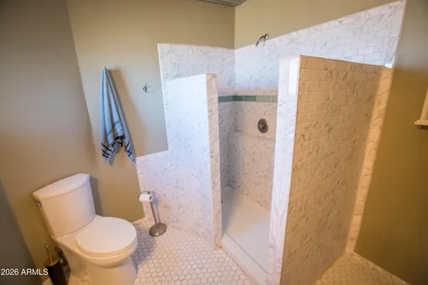 a view of a deck with wooden floor and fence