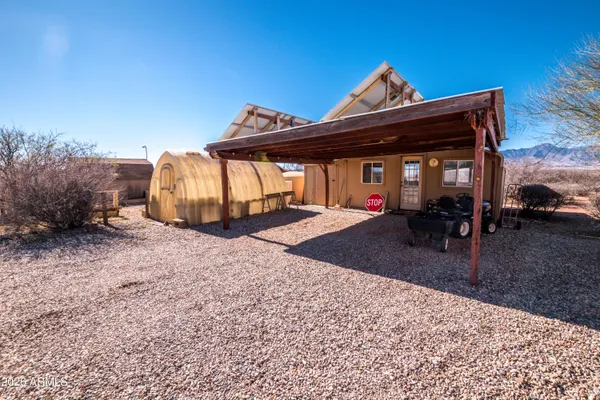 a view of a large buildings with big yard and large trees