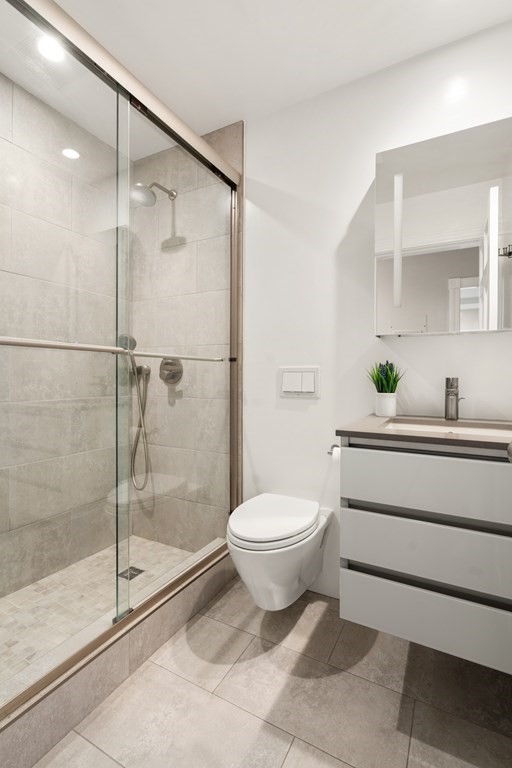 203 St Botolph Street, Unit 4 Boston, MA 02115 - Photo 11 of 26 a bathroom with a toilet sink and shower