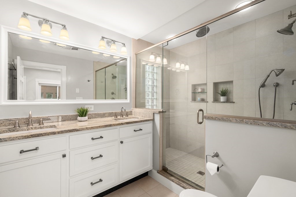 203 St Botolph Street, Unit 4 Boston, MA 02115 - Photo 18 of 26 a bathroom with a granite countertop sink mirror and a shower