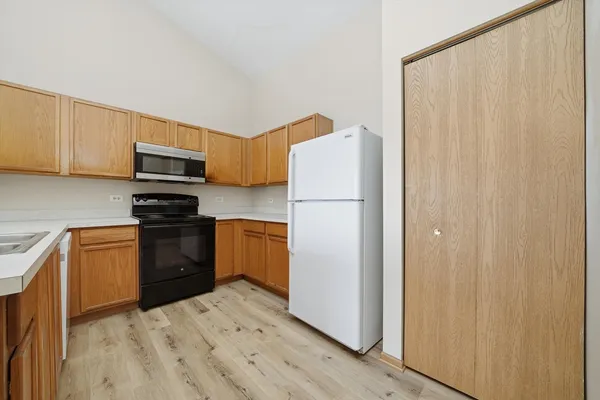 a kitchen with a refrigerator sink and microwave