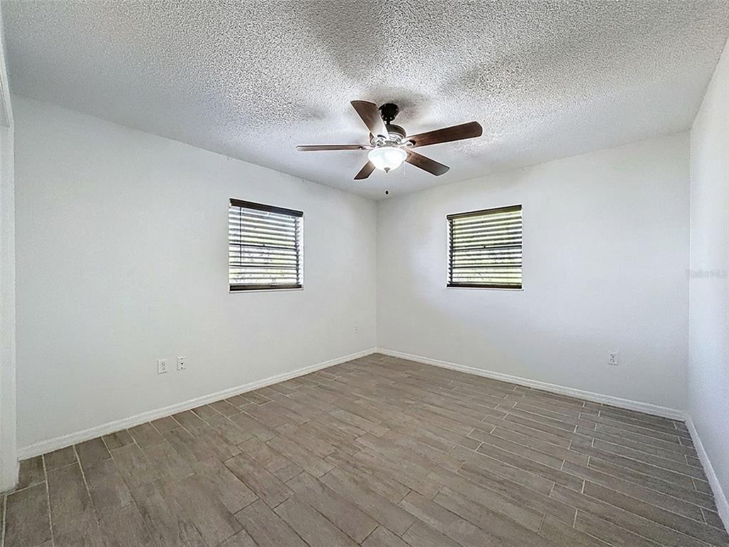 7410 Dundee Court Weeki Wachee, FL 34613 - Photo 23 of 33 wooden floor in an empty room with a window