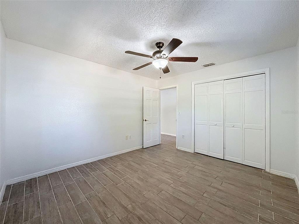 7410 Dundee Court Weeki Wachee, FL 34613 - Photo 25 of 33 a view of an empty room with a fan