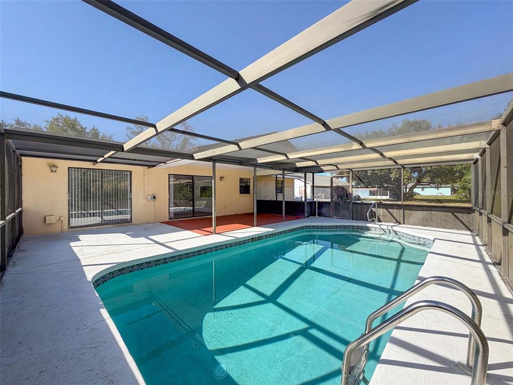 7410 Dundee Court Weeki Wachee, FL 34613 - Photo 32 of 33 a view of a backyard with a patio and deck