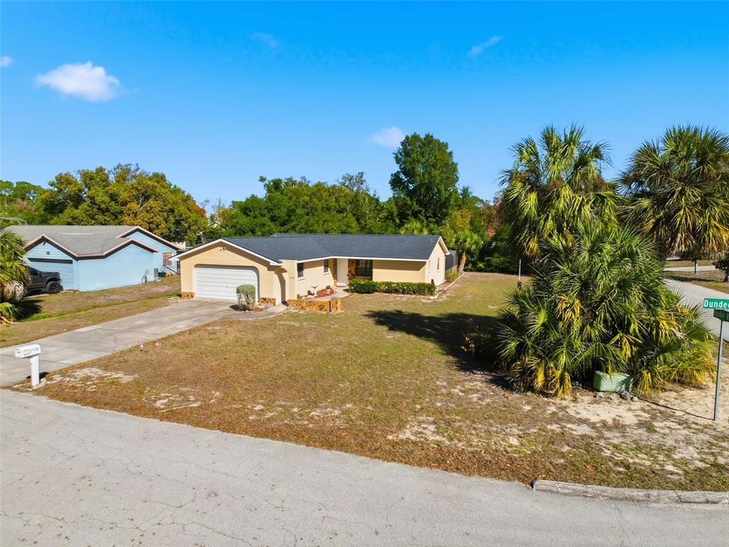 7410 Dundee Court Weeki Wachee, FL 34613 - Photo 5 of 33 a front view of a house with a yard and garage