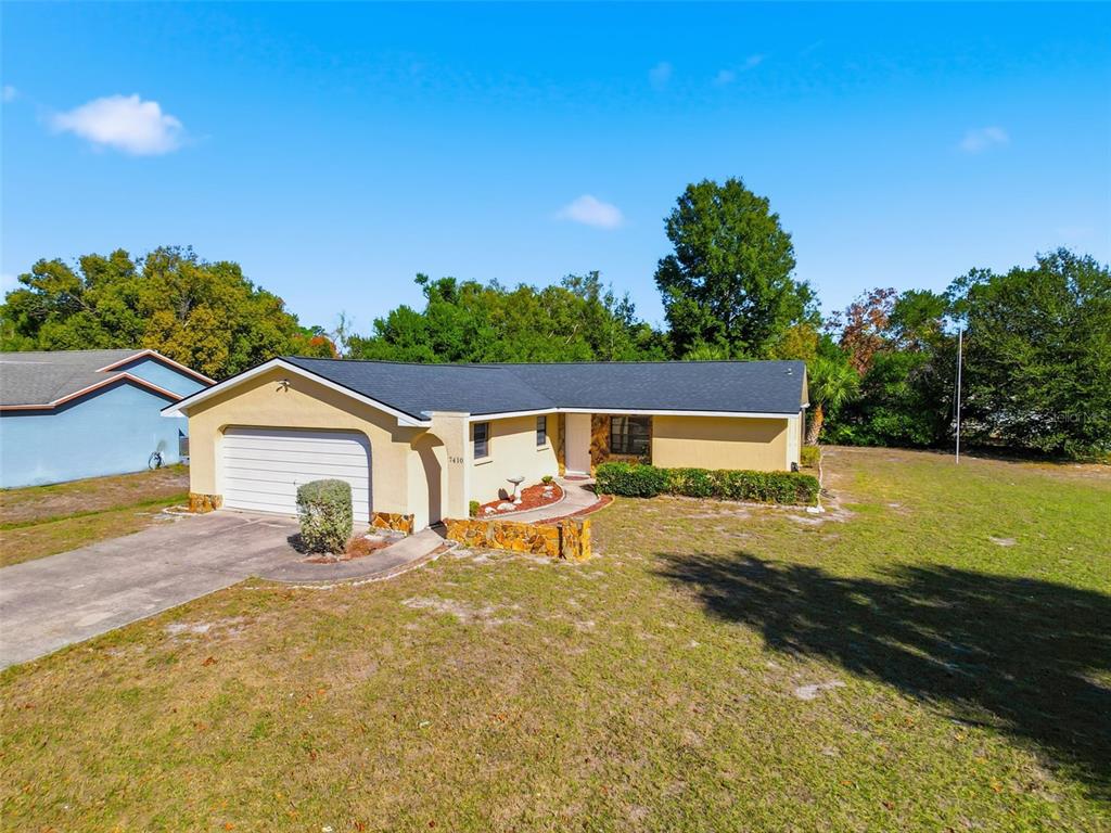 7410 Dundee Court Weeki Wachee, FL 34613 - Photo 7 of 33 a view of a yard with a house in the background
