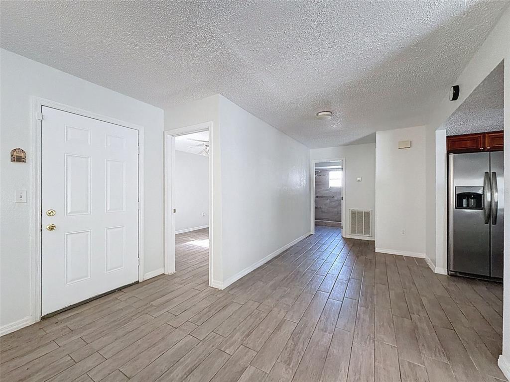 7410 Dundee Court Weeki Wachee, FL 34613 - Photo 10 of 33 a view of empty room with wooden floor