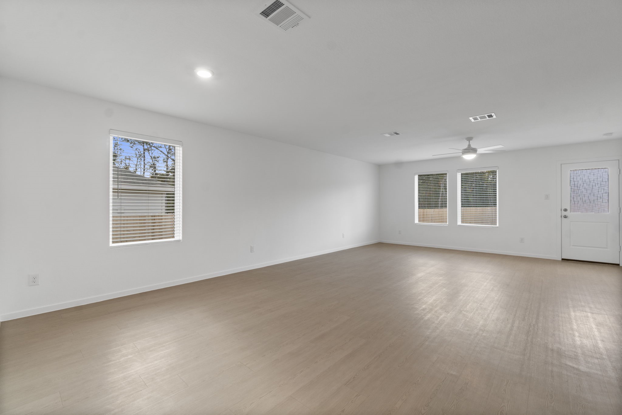 16031 Tallis Drive Conroe, TX 77303 - Photo 14 of 46 an empty room with a empty space and windows