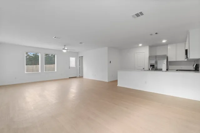a view of a kitchen with a sink stove and a refrigerator
