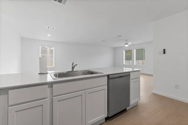 an empty room with fan and fan