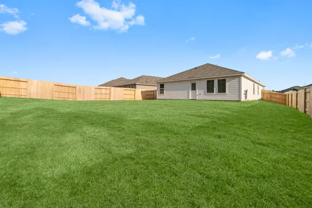 a view of a house with a yard and sitting area