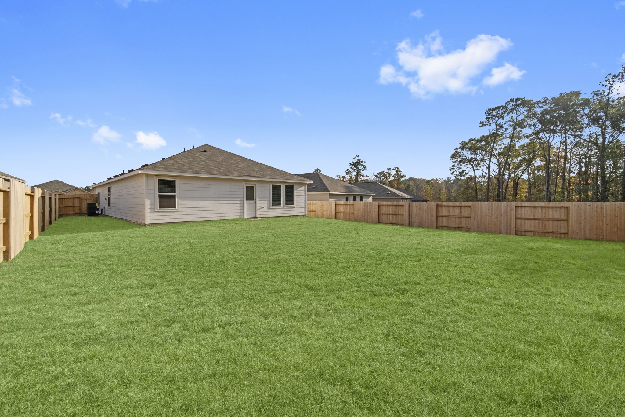16031 Tallis Drive Conroe, TX 77303 - Photo 31 of 46 a view of a house with a yard and sitting area