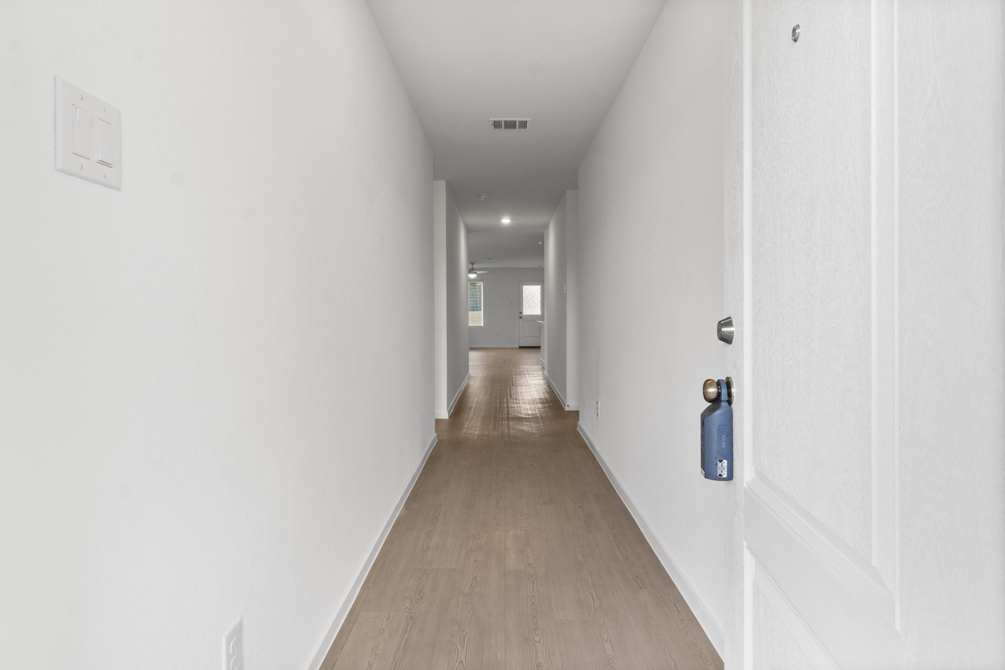 16031 Tallis Drive Conroe, TX 77303 - Photo 5 of 46 a view of a hallway with wooden floor