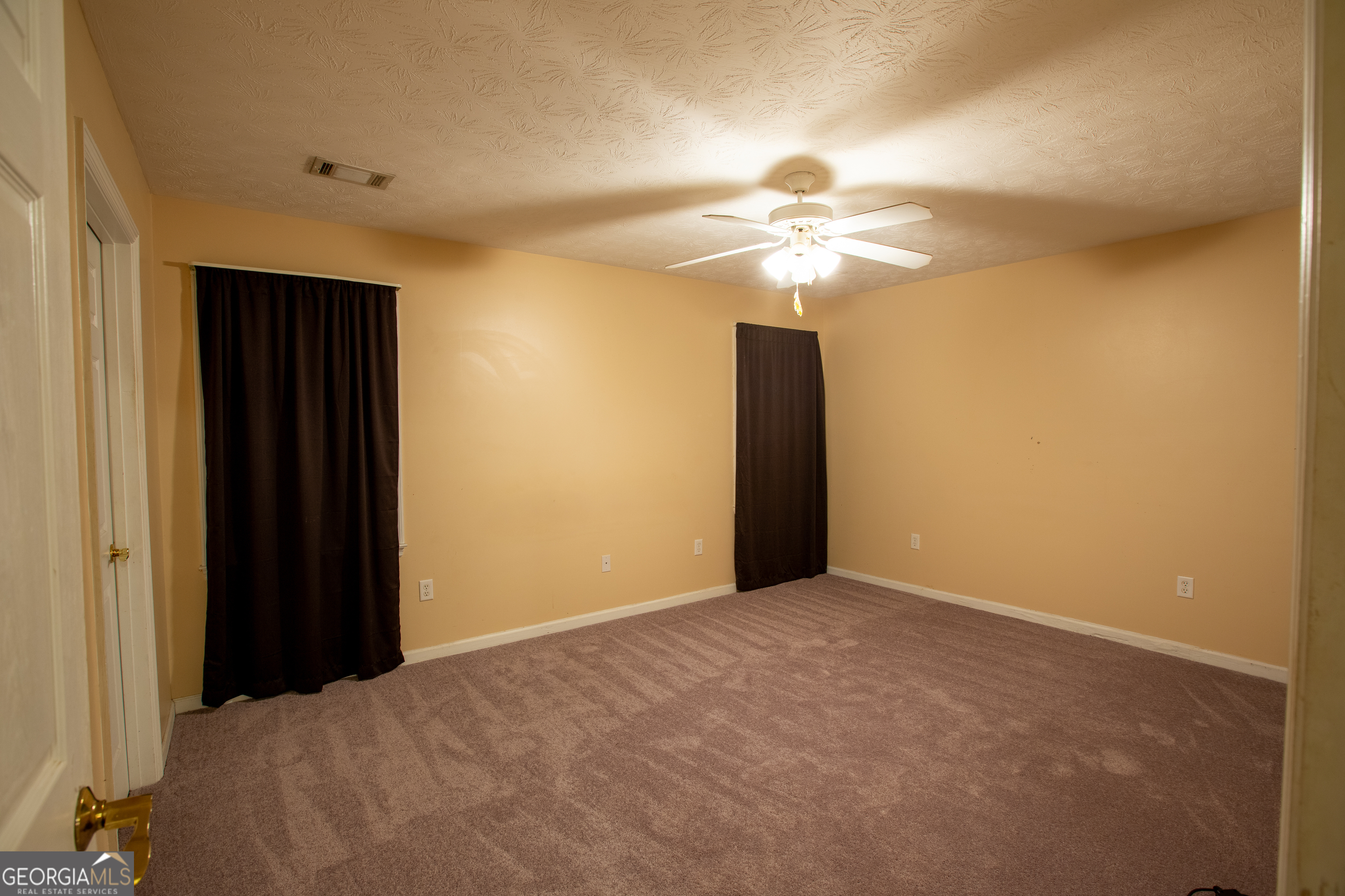 2801 8th Street Columbus, GA 31906 - Photo 17 of 20 a view of a big room with closet and a ceiling fan