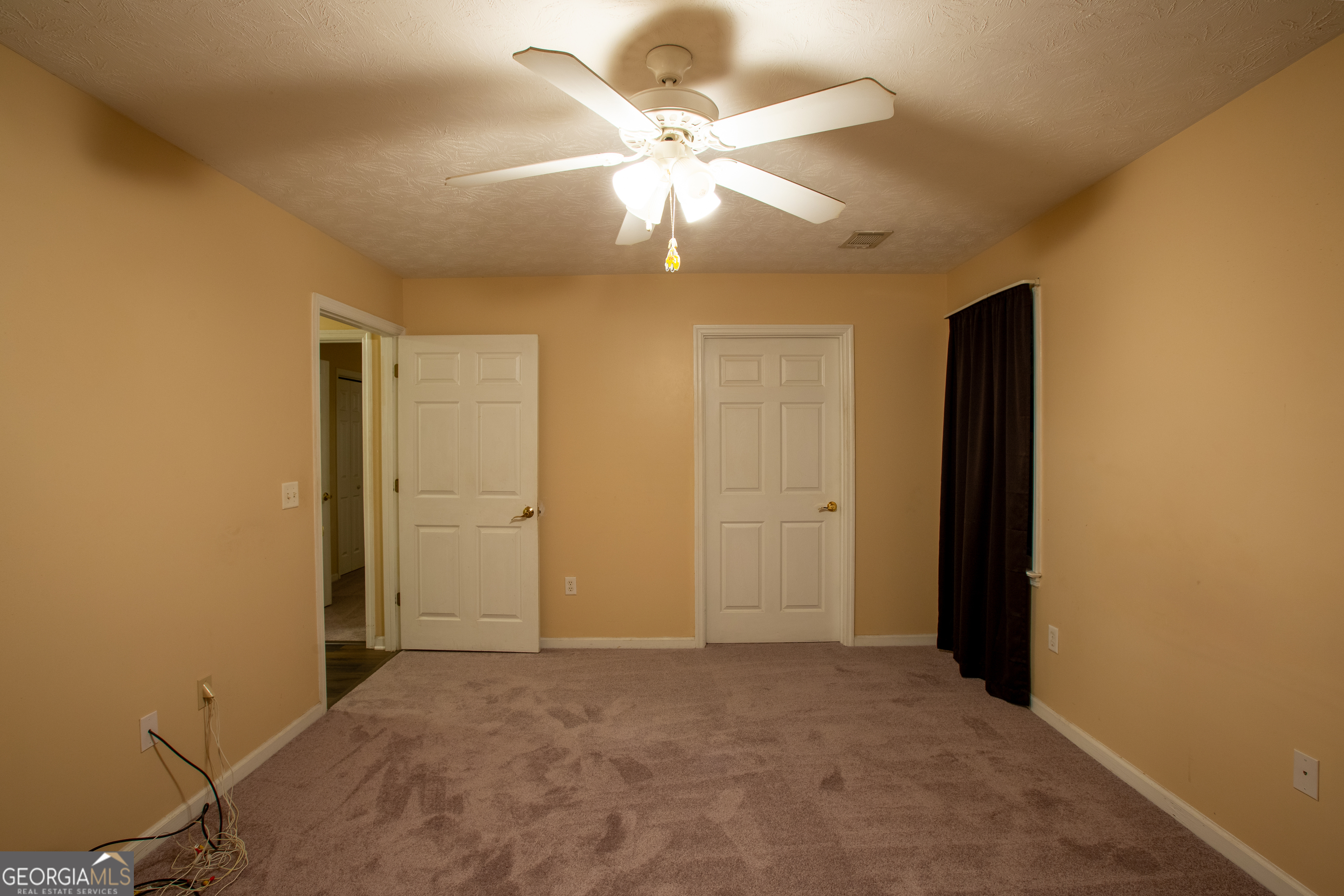2801 8th Street Columbus, GA 31906 - Photo 18 of 20 an empty room with closet and a chandelier fan