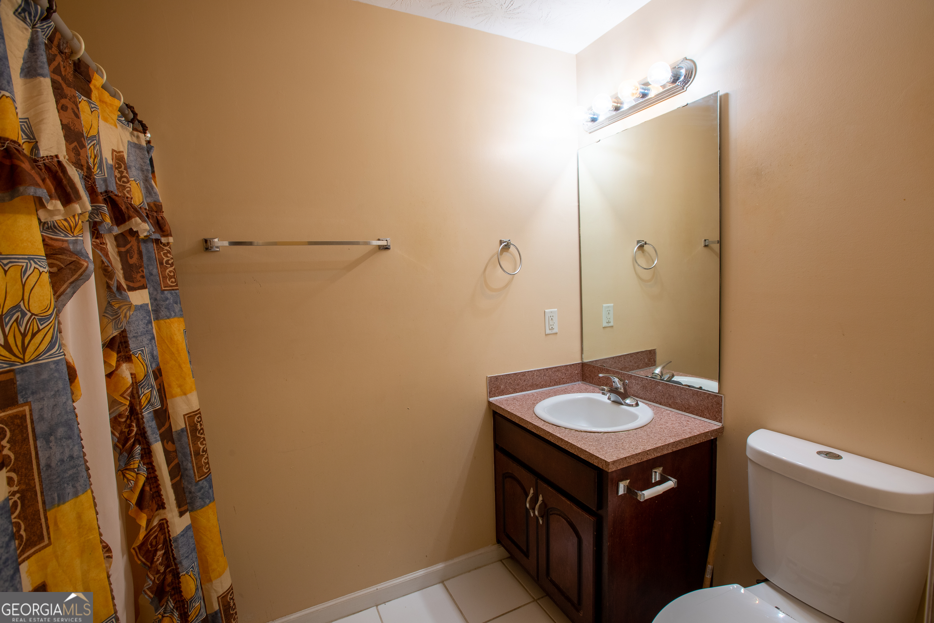 2801 8th Street Columbus, GA 31906 - Photo 20 of 20 a bathroom with a granite countertop sink and a mirror