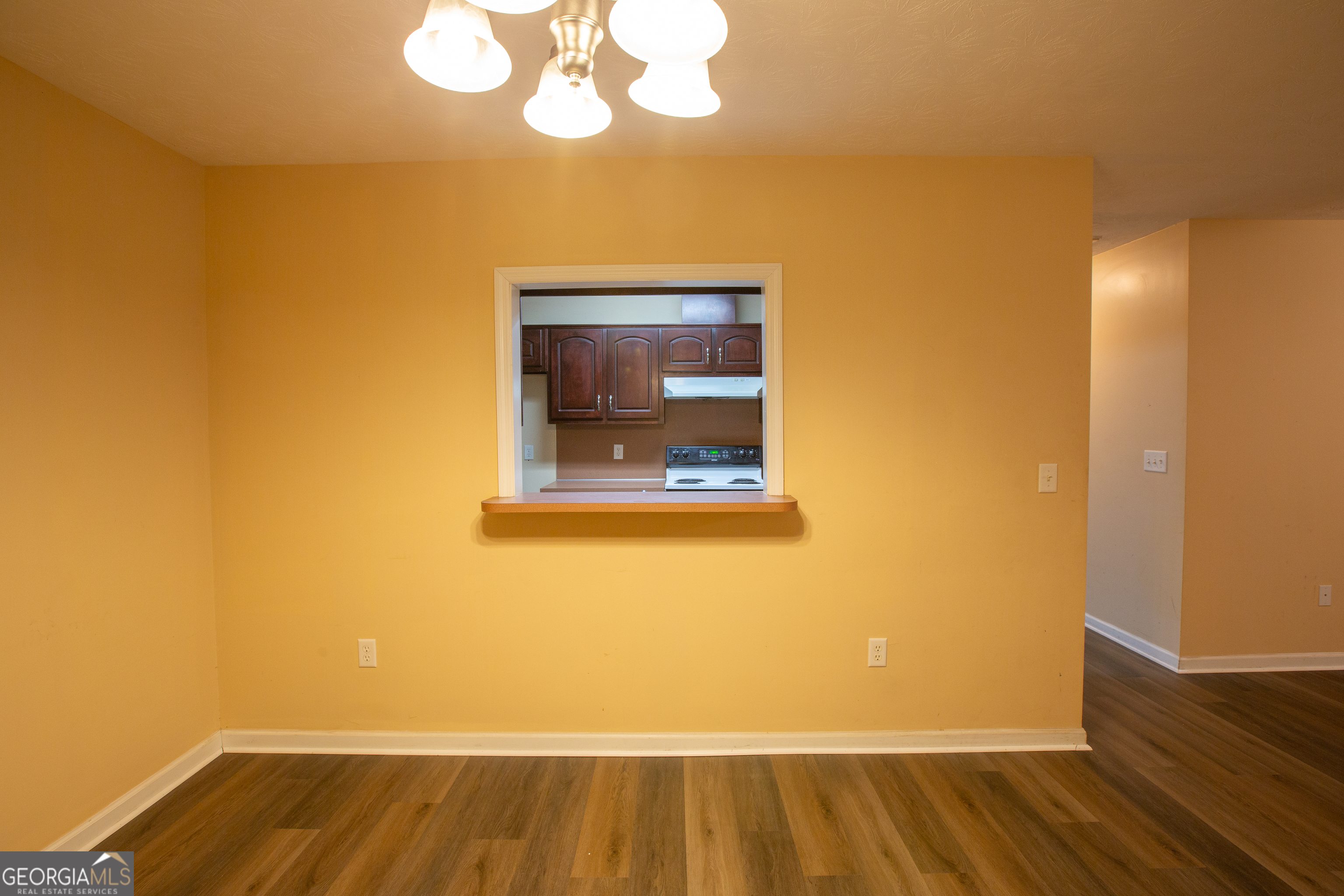 2801 8th Street Columbus, GA 31906 - Photo 6 of 20 a view of a room with wooden floor and a ceiling fan