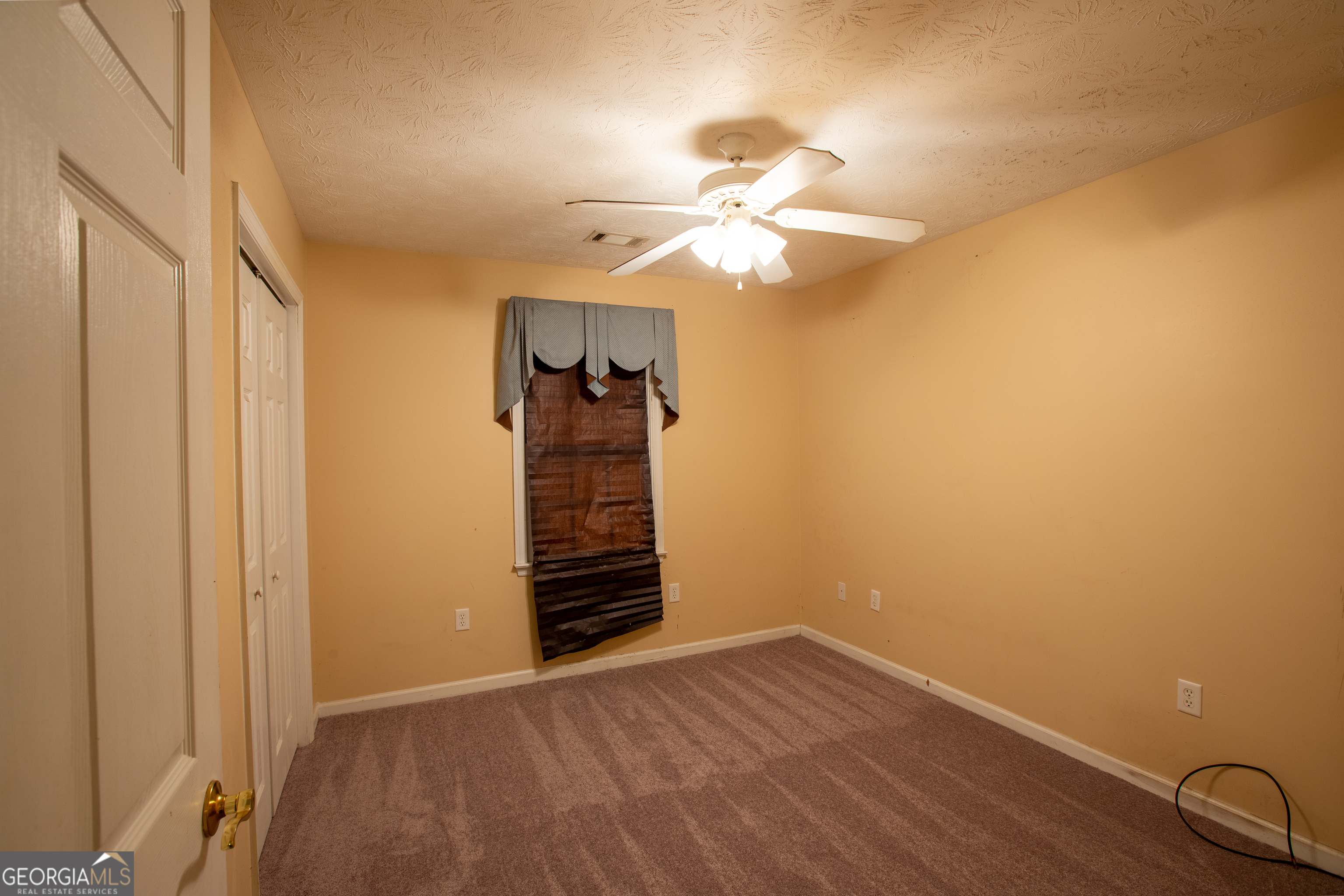 2801 8th Street Columbus, GA 31906 - Photo 10 of 20 an empty room with windows and fan