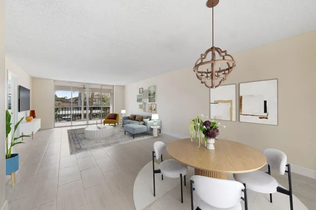 a view of a dining room with furniture wooden floor and chandelier