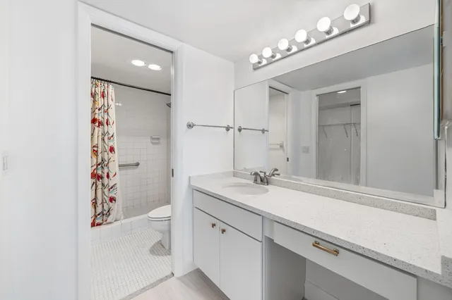 a bathroom with a sink a vanity and a mirror
