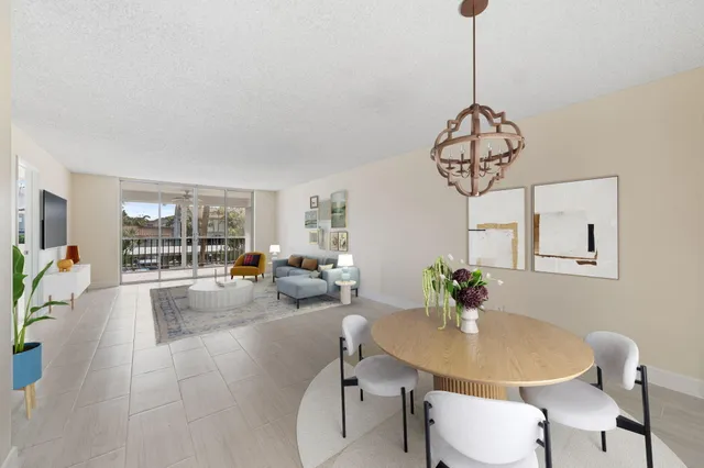 a view of a dining room with furniture wooden floor and chandelier