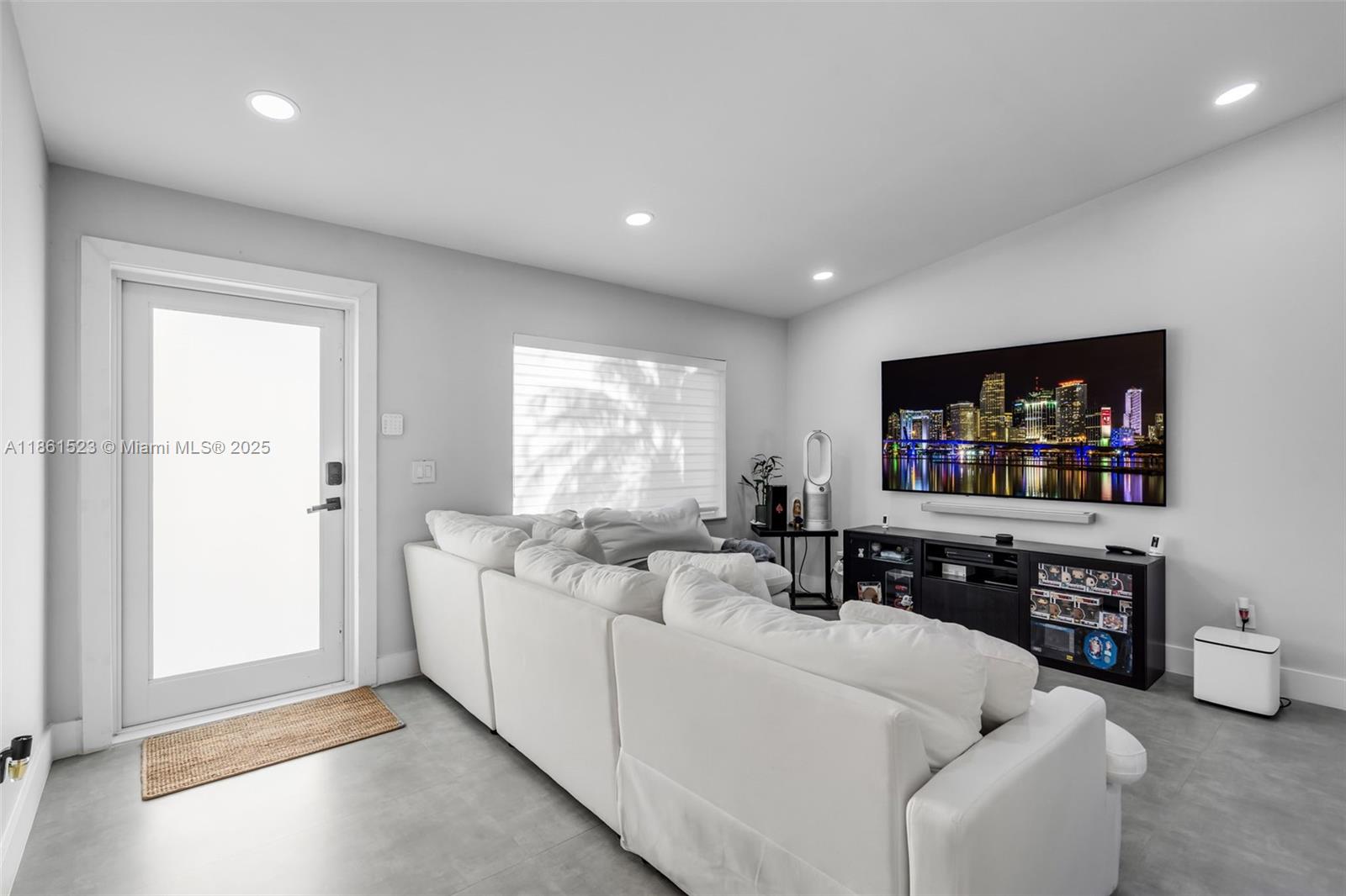 1120 Southwest 128th Drive Davie, FL 33325 - Photo 12 of 38 a living room with furniture and a flat screen tv