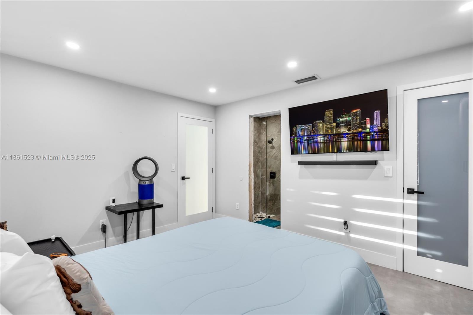 1120 Southwest 128th Drive Davie, FL 33325 - Photo 15 of 38 a bedroom with a bed and a flat screen tv