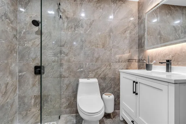 a bathroom with a toilet a sink and shower