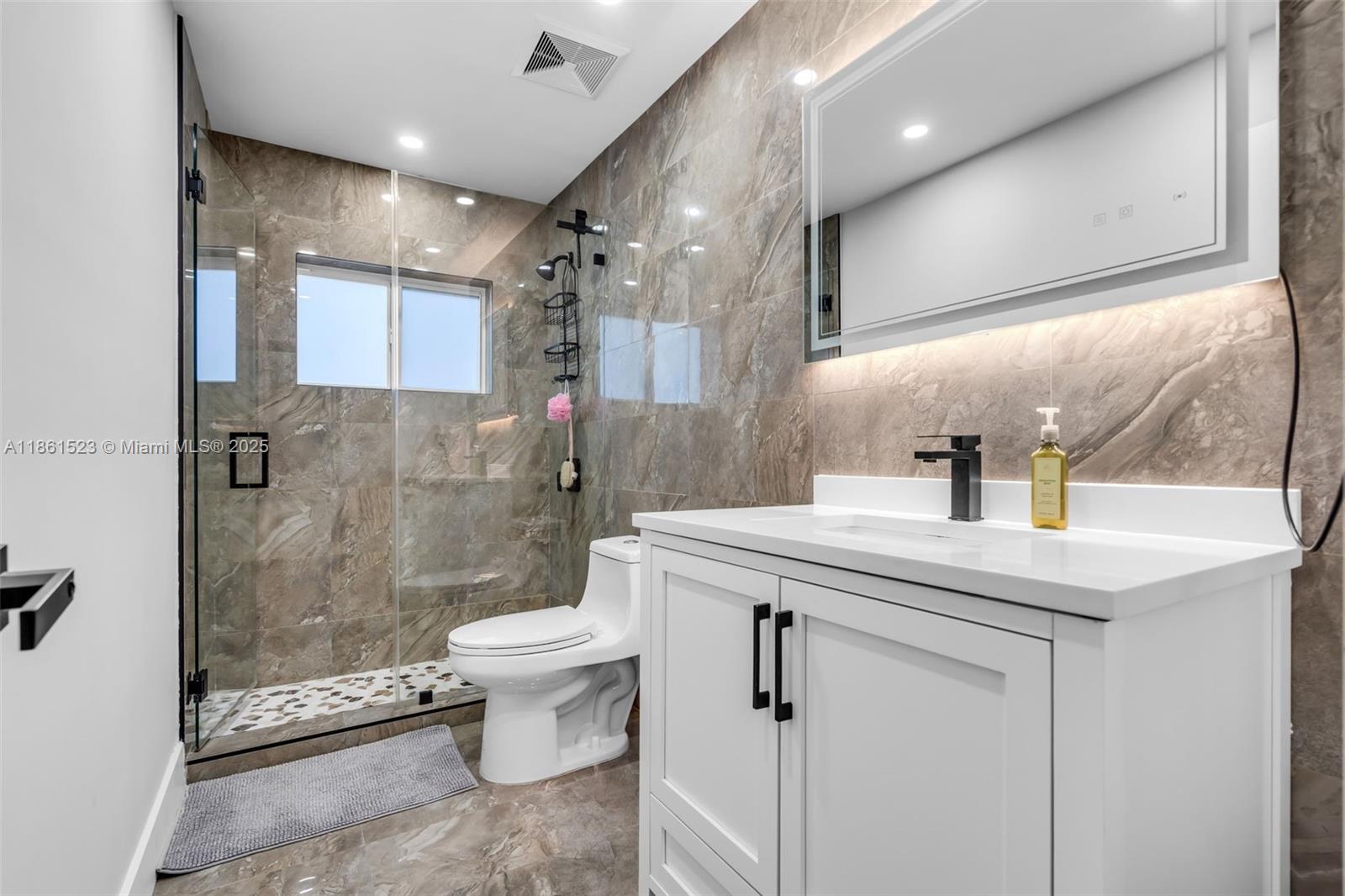 1120 Southwest 128th Drive Davie, FL 33325 - Photo 17 of 38 a bathroom with a sink toilet and shower