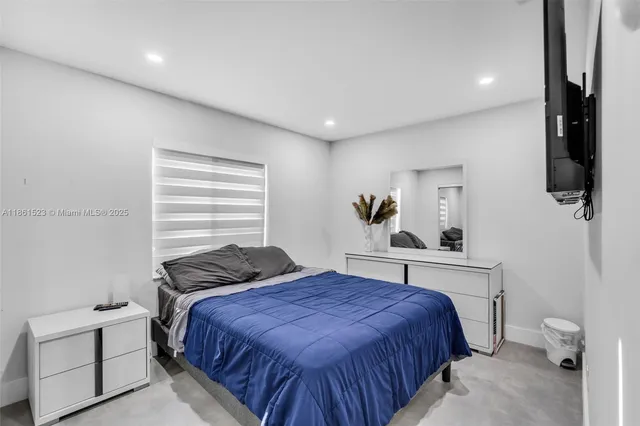 a bedroom with a bed and window