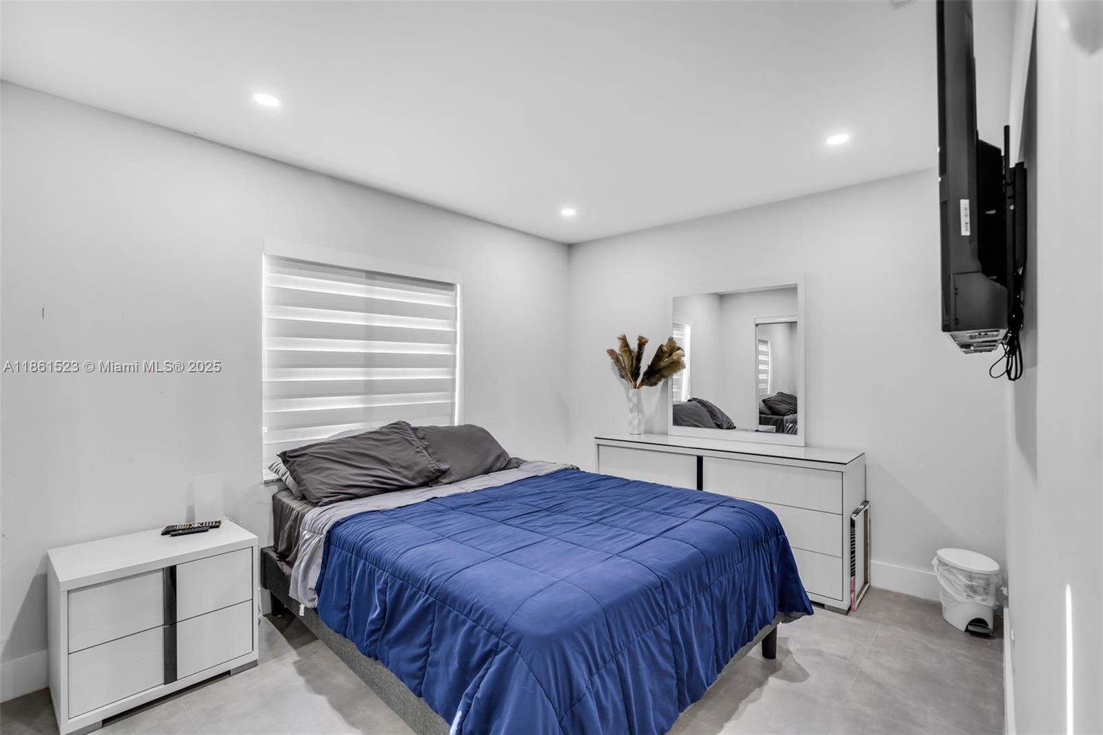 1120 Southwest 128th Drive Davie, FL 33325 - Photo 21 of 38 a bedroom with a bed and window