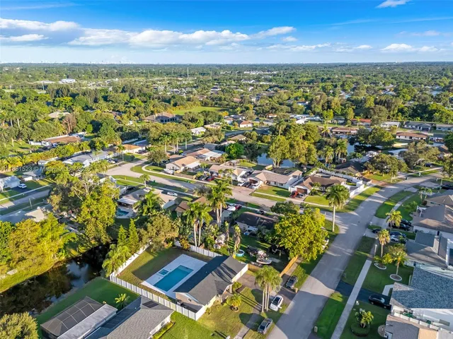 an aerial view of residential houses with outdoor space and street view
