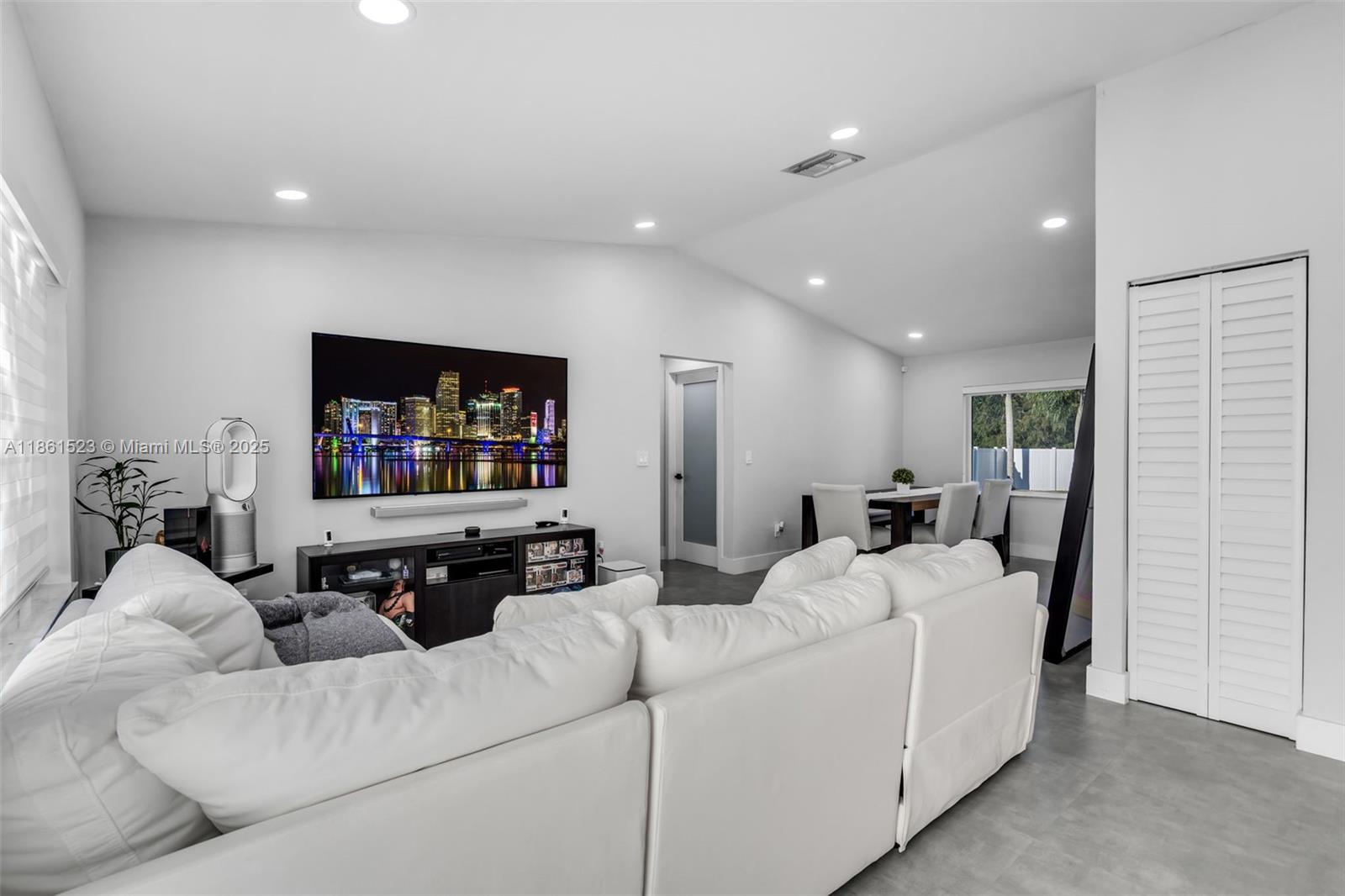 1120 Southwest 128th Drive Davie, FL 33325 - Photo 4 of 38 a living room with furniture and a flat screen tv