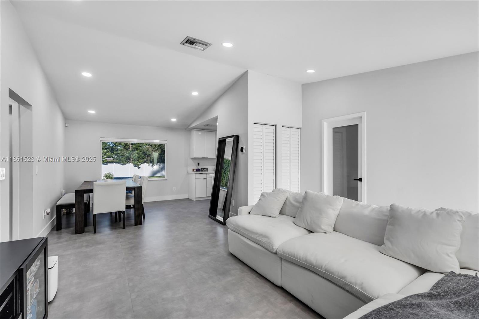 1120 Southwest 128th Drive Davie, FL 33325 - Photo 6 of 38 a living room with furniture a window and a flat screen tv