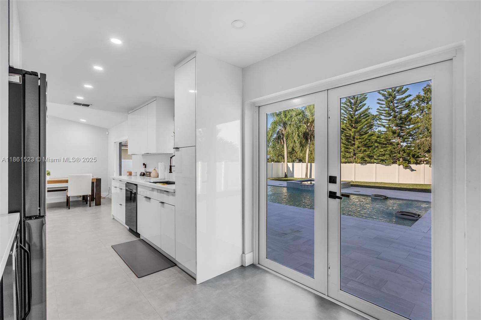 1120 Southwest 128th Drive Davie, FL 33325 - Photo 10 of 38 a open kitchen with white cabinets and stainless steel appliances