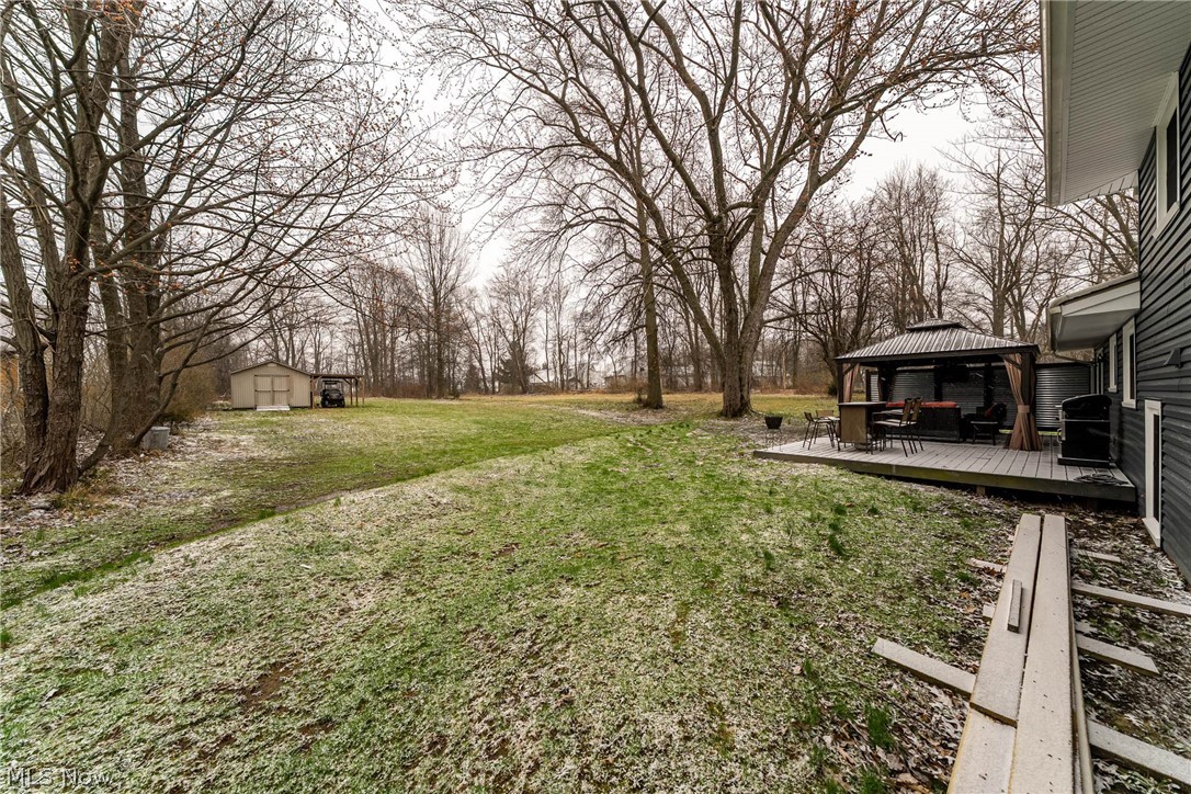 7791 Ridge Road Parma, OH 44129 - Photo 37 of 41 View of grassy yard with a gazebo, a wooden deck, and a storage shed