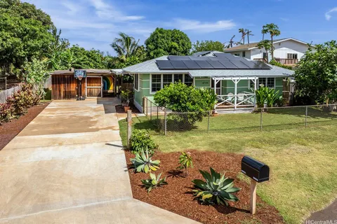 a front view of a house with a garden