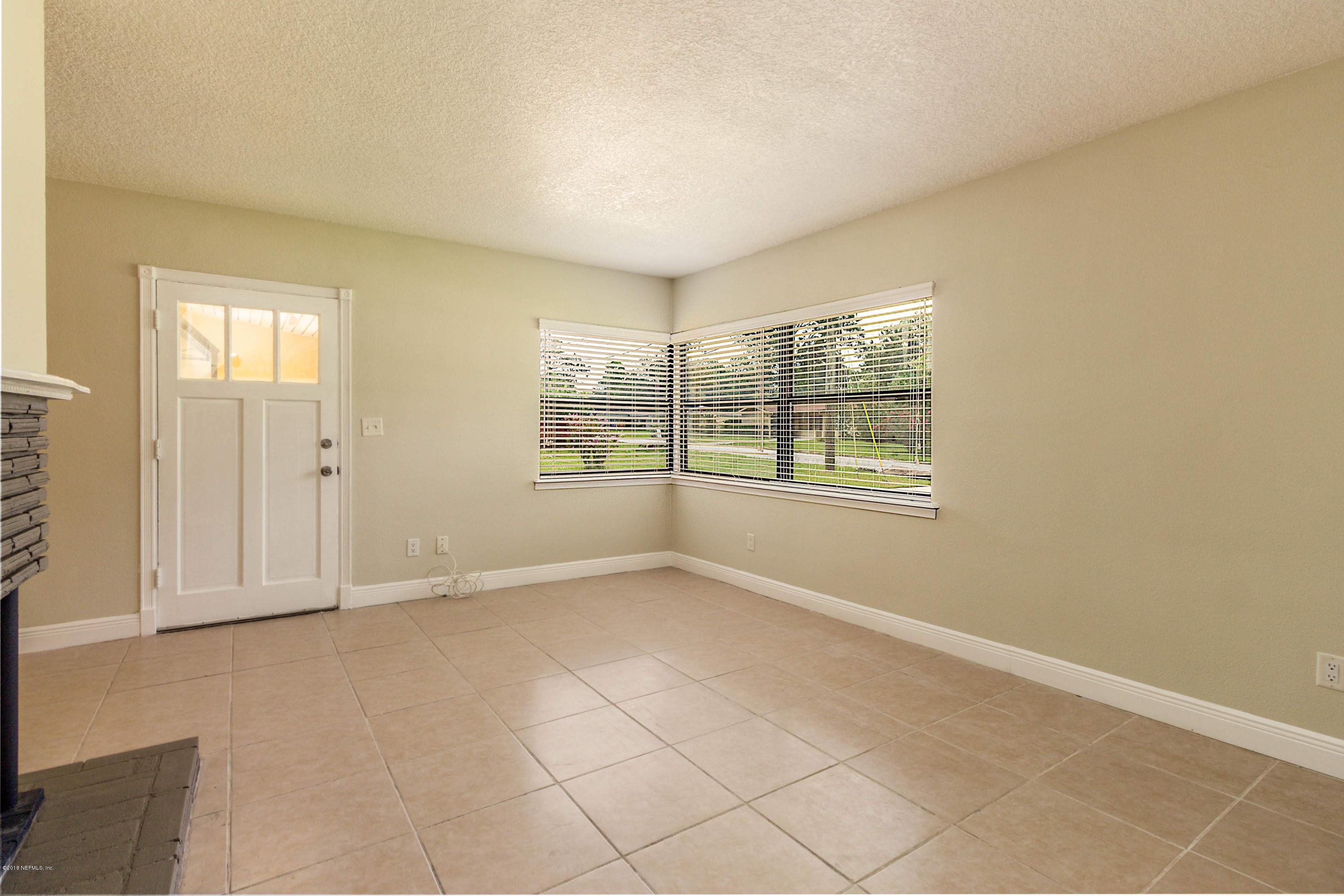6334 Suwanee Road Jacksonville, FL 32217 - Photo 3 of 17 an empty room with windows