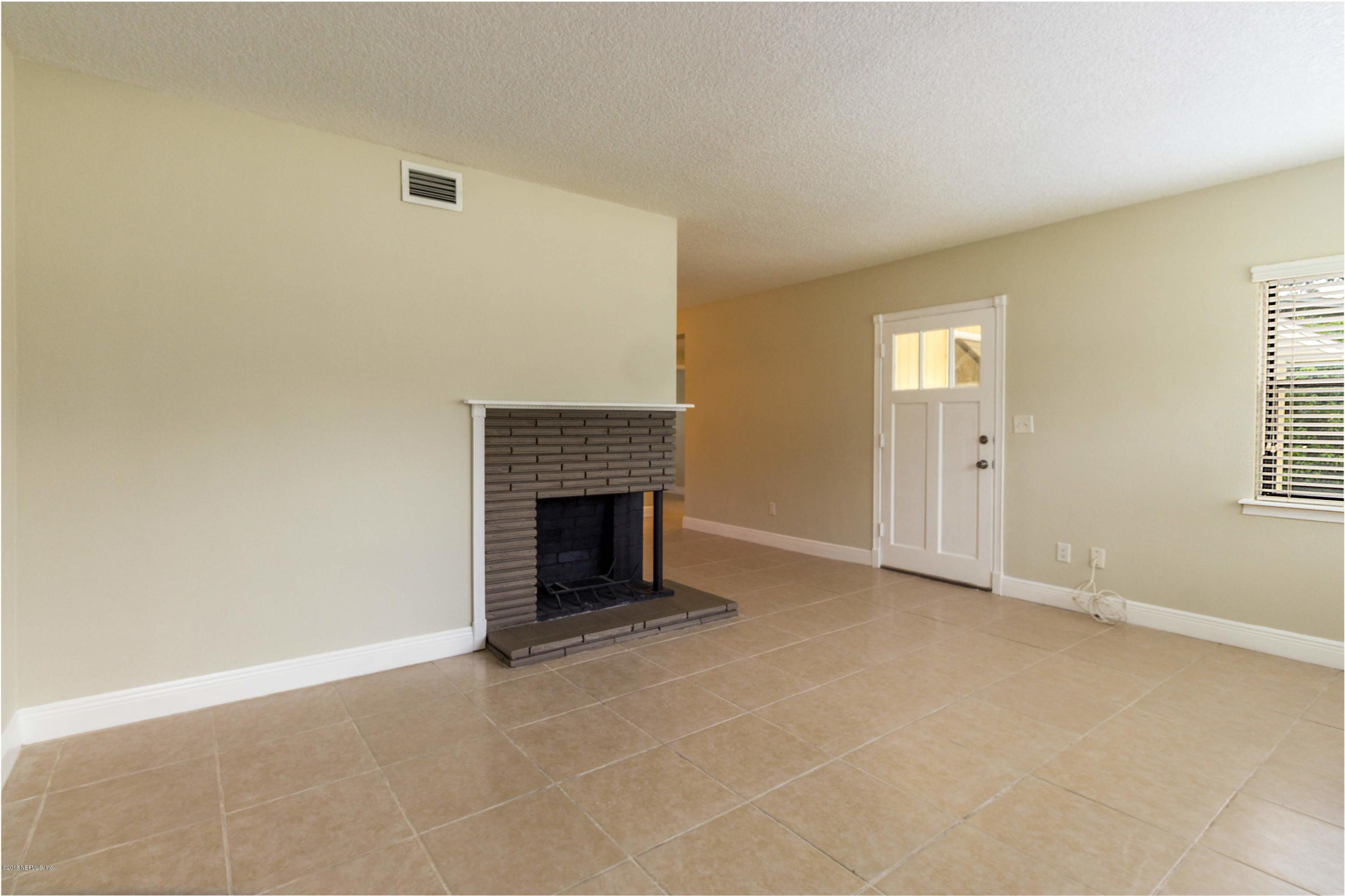 6334 Suwanee Road Jacksonville, FL 32217 - Photo 4 of 17 an empty room with windows