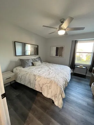 a bedroom with a bed and a mirror