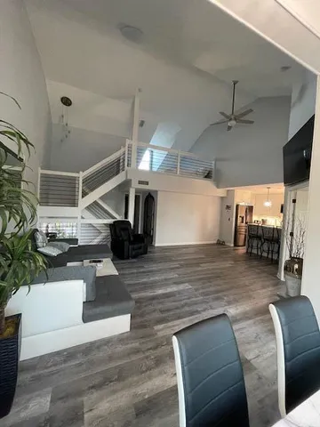 a view of a livingroom with furniture and a ceiling fan