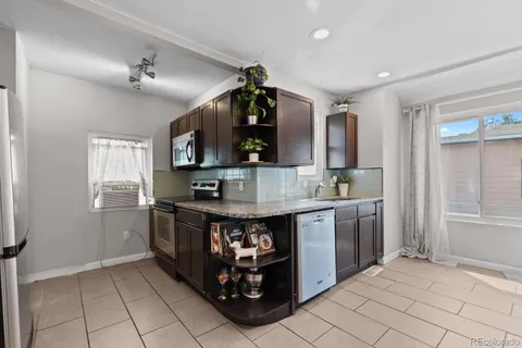 a kitchen with stainless steel appliances granite countertop a stove and a sink