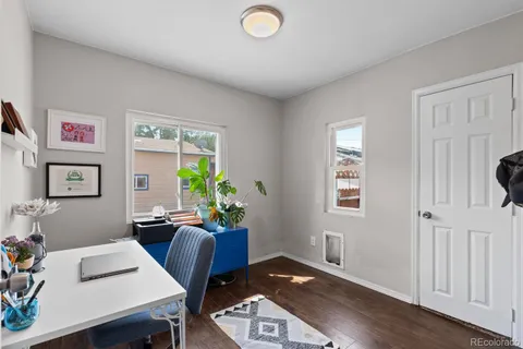 a view of a workspace with furniture and a window
